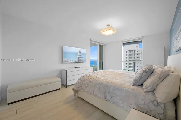 a bedroom with a bed and a couch