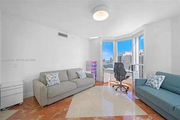 a living room with furniture and a rug