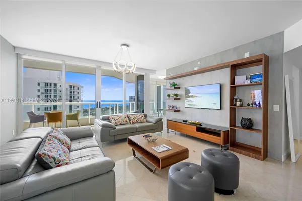 a living room with furniture and a chandelier