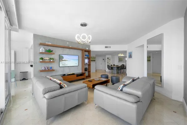 a living room with furniture and a chandelier