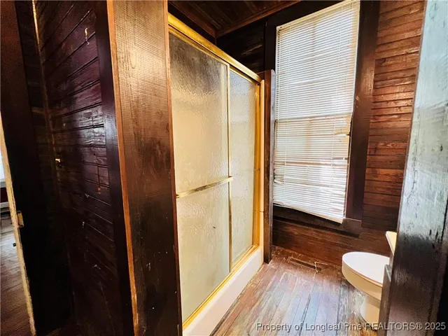 a living room with a bed and a window