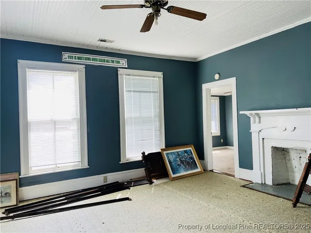 a hallway with white cabinets and wooden floor