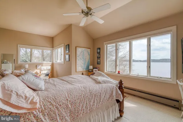 a bedroom with a large bed and a large window