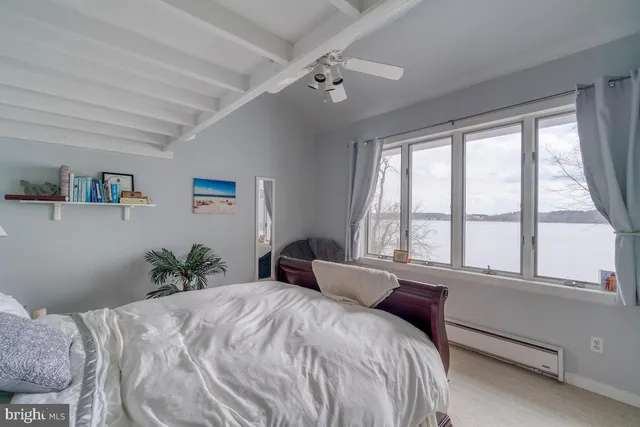 a bedroom with a large bed and a large window