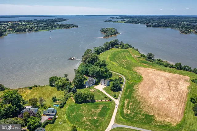 an aerial view of a residential houses with outdoor space and seating