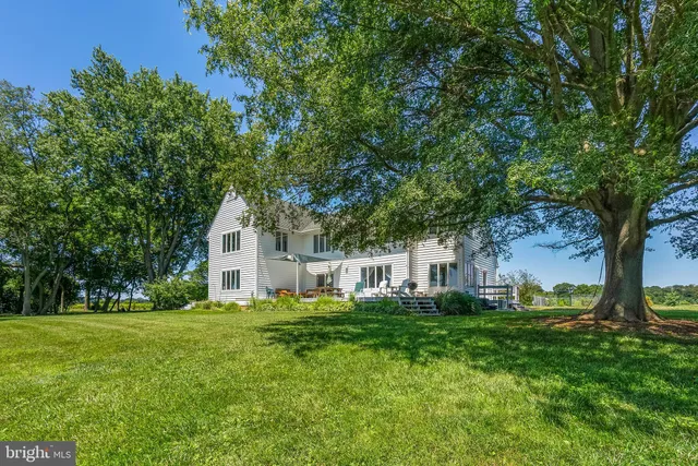 a house view with swimming pool and garden