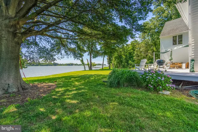 a view of yard with swimming pool and green space