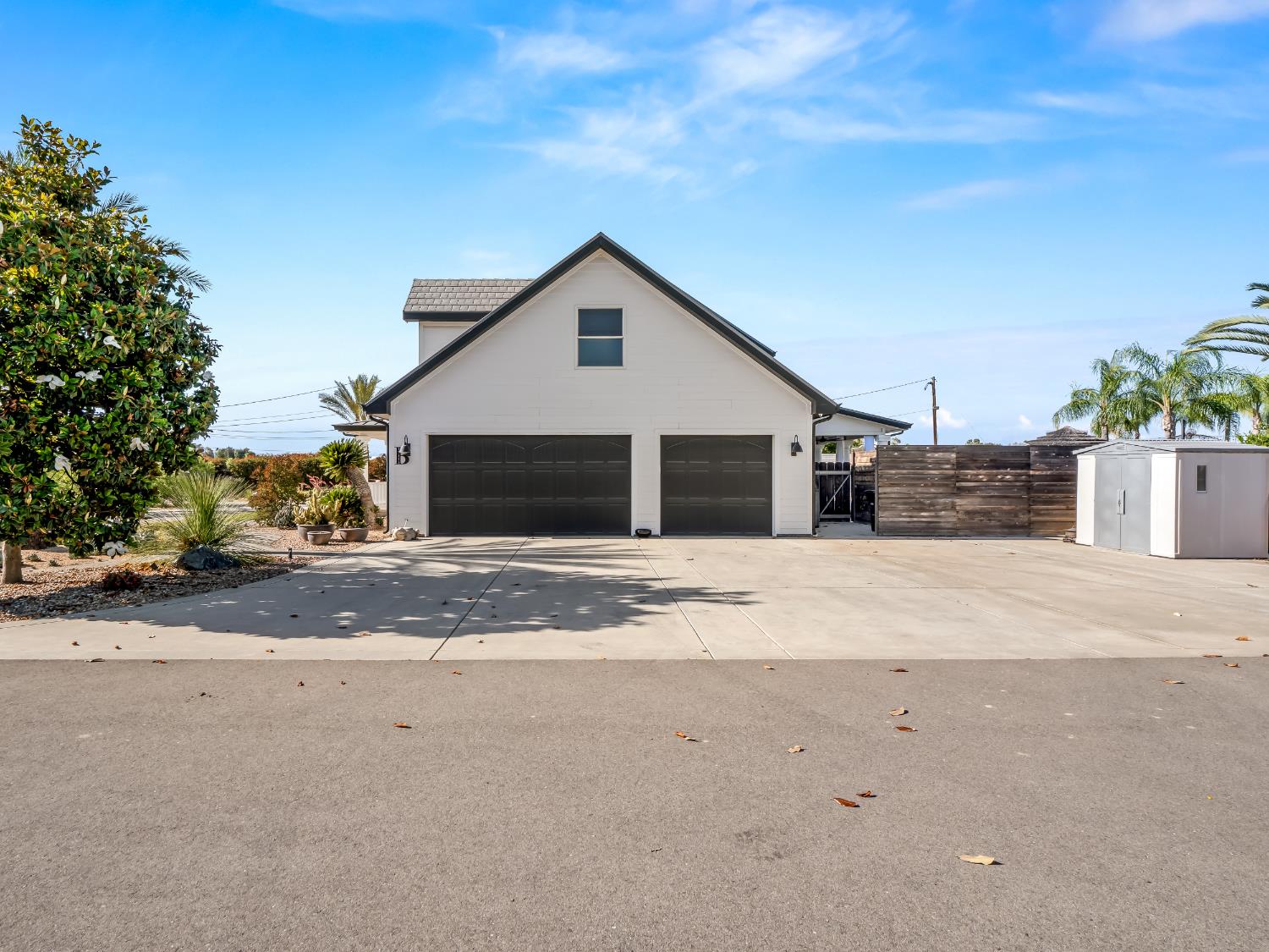 17113 Mark Road Madera, CA 93636 - Photo 52 of 99 a front view of a house with a yard and garage