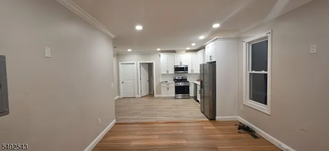a view of a kitchen with a hallway