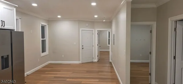 a view of hallway with wooden floor