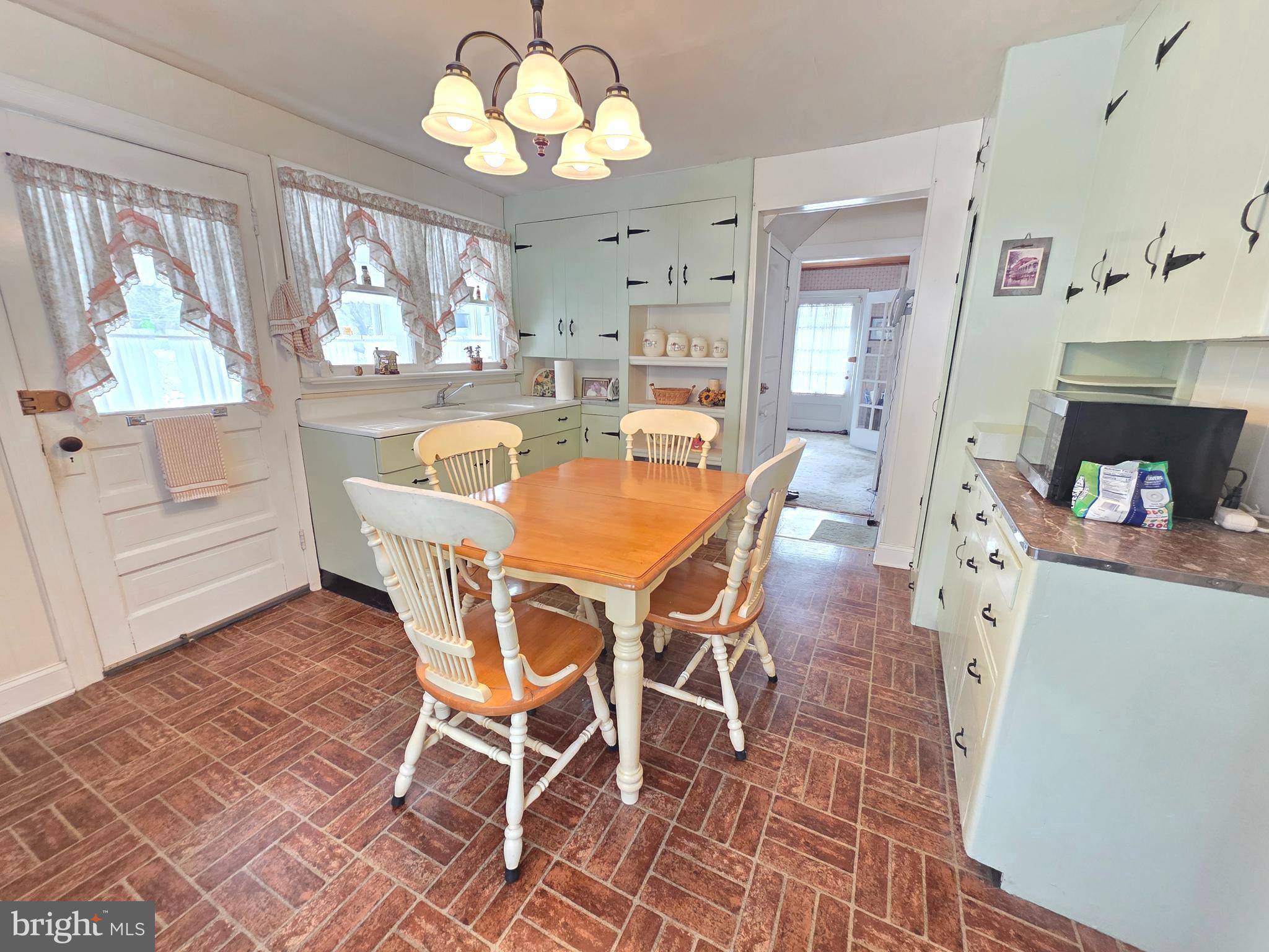 3016 County House Road Woodbury, NJ 08096 - Photo 9 of 19 a view of a dining room with furniture a chandelier and wooden floor
