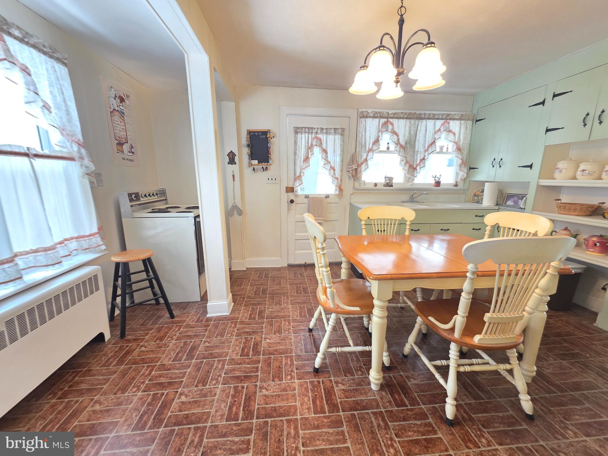 3016 County House Road Woodbury, NJ 08096 - Photo 10 of 19 a dining room with furniture a chandelier and wooden floor