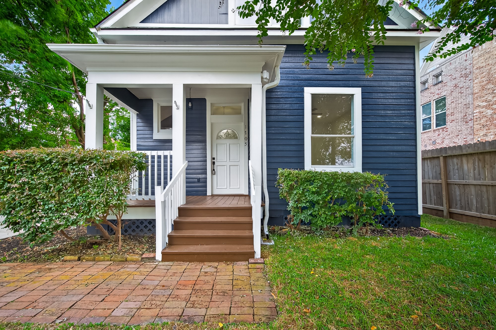1705 Ovid Street Houston, TX 77007 - Photo 1 of 30 a view of a house with brick walls and a yard with plants
