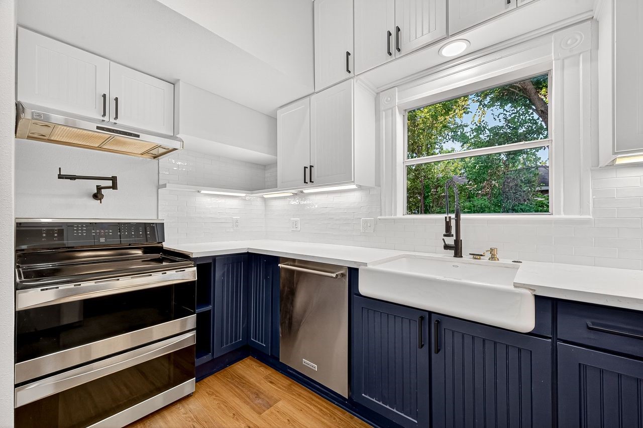 1705 Ovid Street Houston, TX 77007 - Photo 11 of 30 a kitchen with stainless steel appliances a sink stove and cabinets