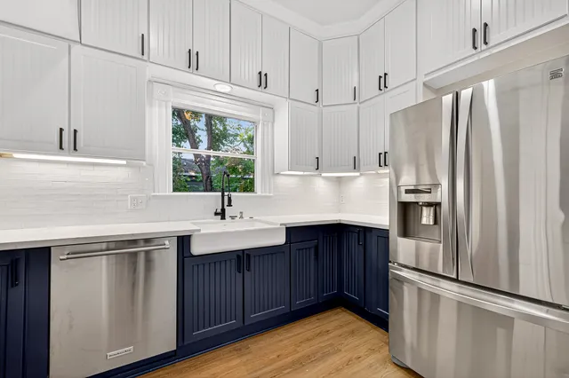 a kitchen with stainless steel appliances granite countertop a refrigerator sink and cabinets