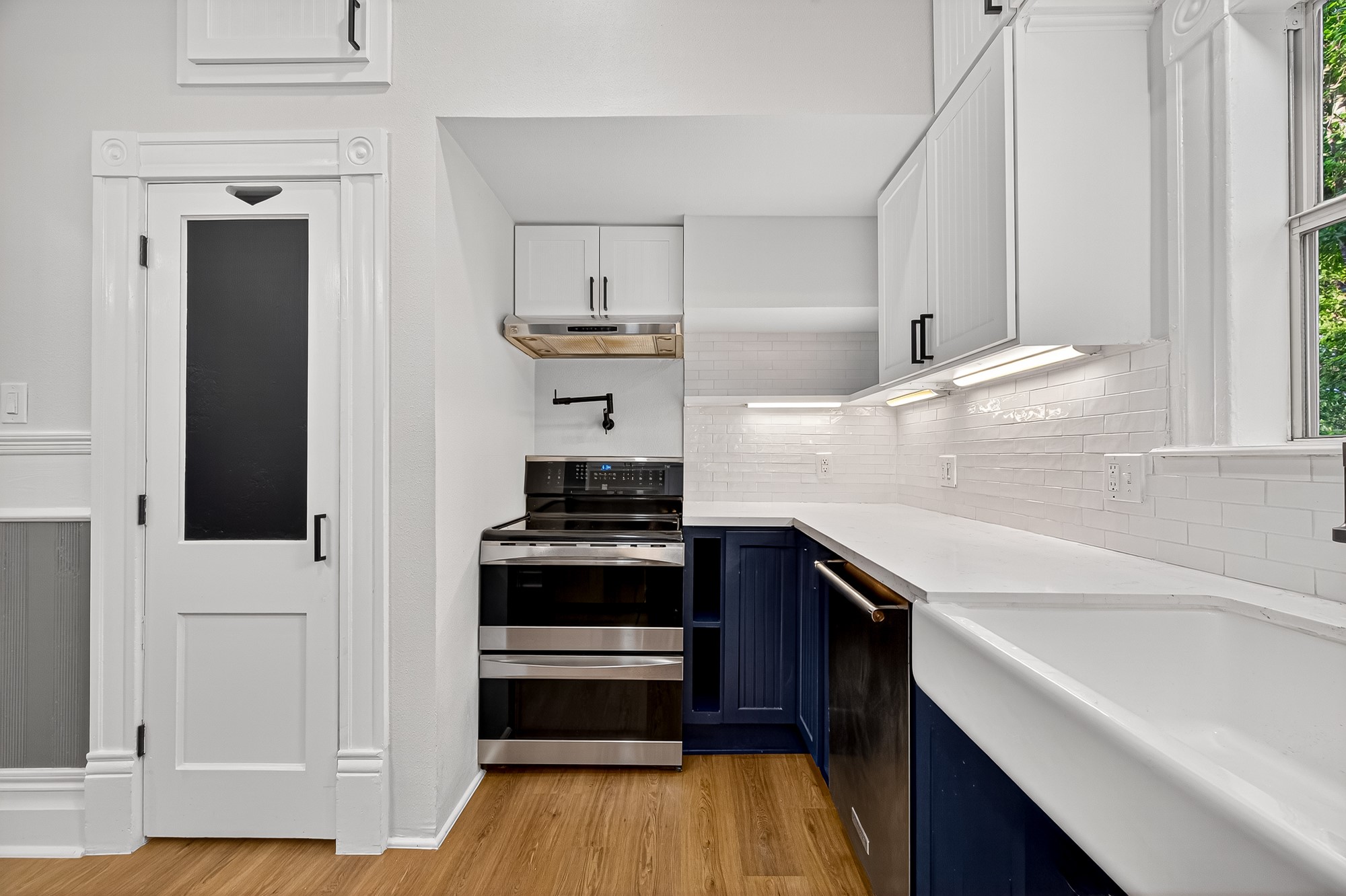 1705 Ovid Street Houston, TX 77007 - Photo 13 of 30 a kitchen with stainless steel appliances cabinets and a wooden floor