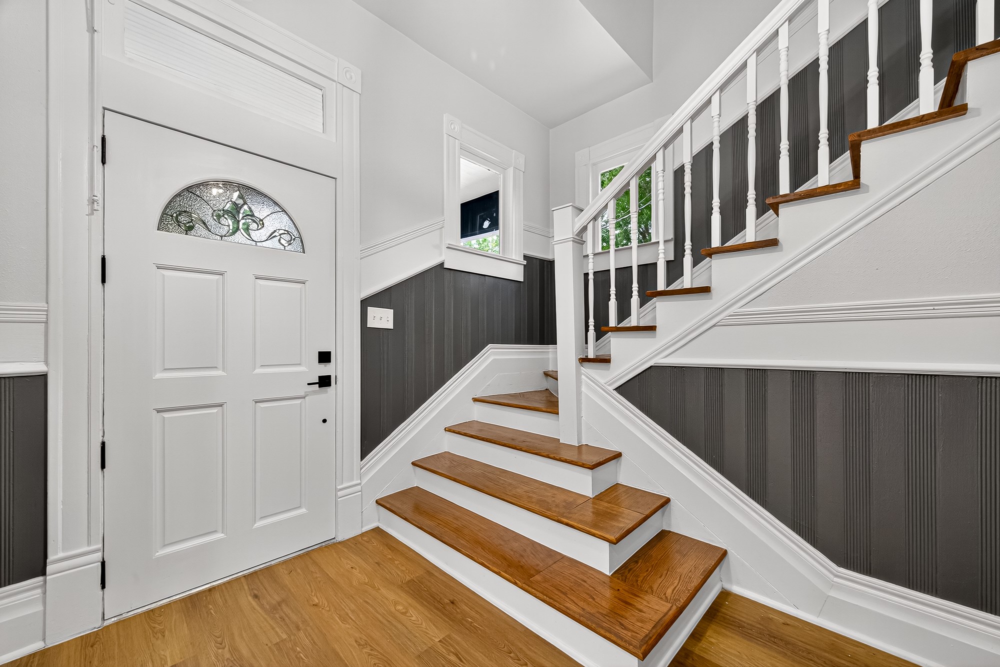 1705 Ovid Street Houston, TX 77007 - Photo 4 of 30 a view of staircase with lots of frames on wall and a large window