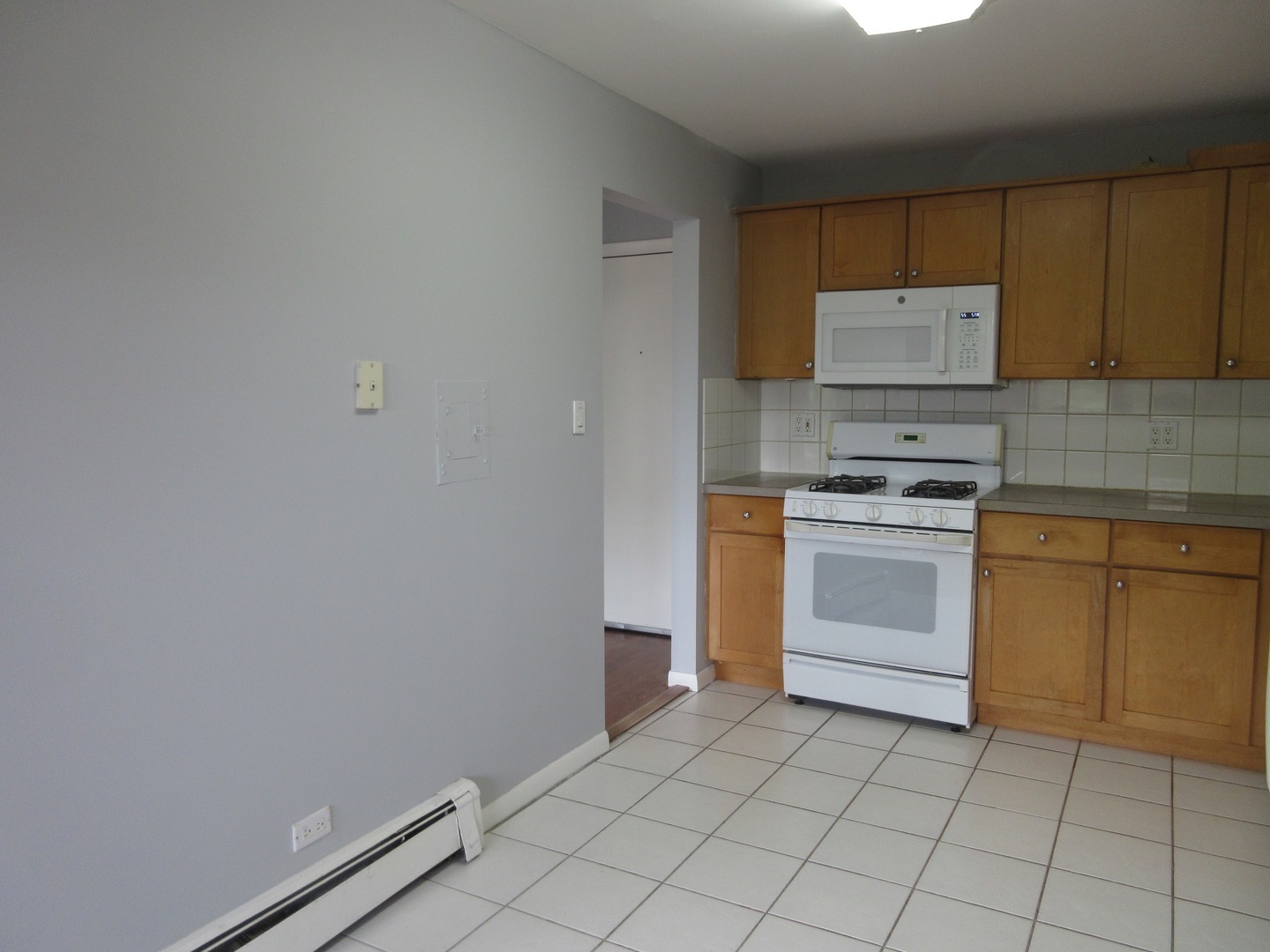 7255 North Ridge Boulevard, Unit 403 Chicago, IL 60645 - Photo 23 of 30 a kitchen with a stove sink and cabinets