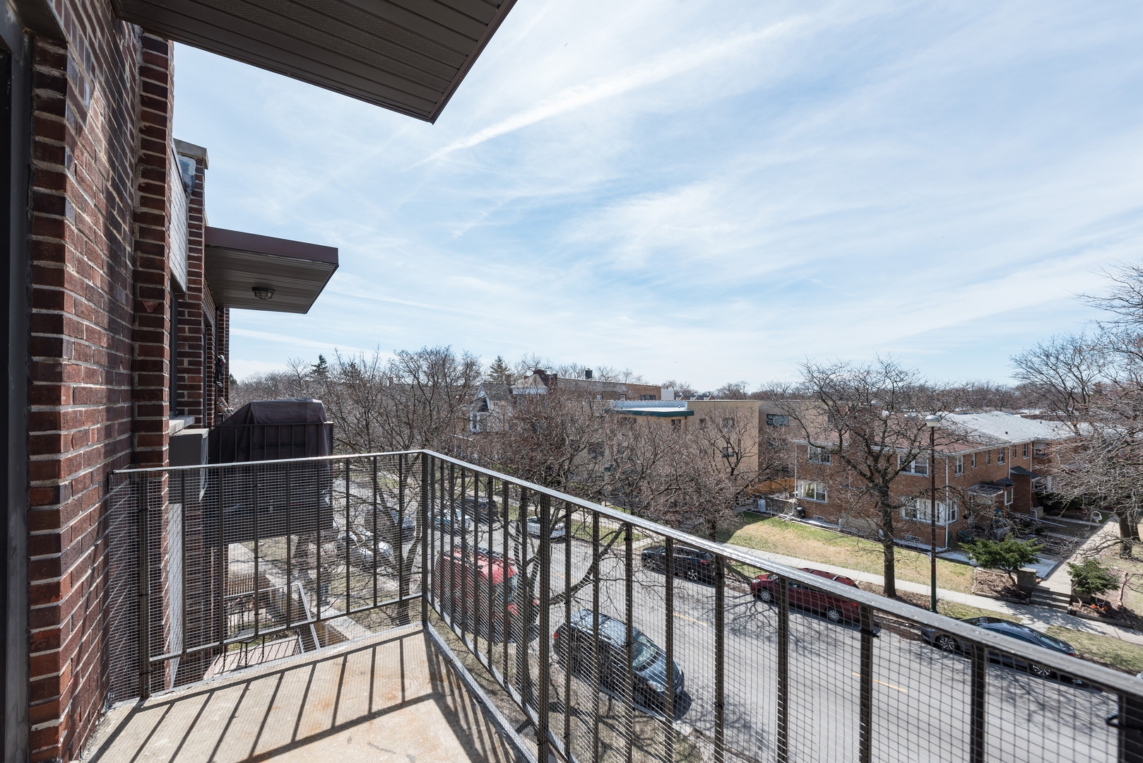 7255 North Ridge Boulevard, Unit 403 Chicago, IL 60645 - Photo 8 of 30 a view of a balcony with a floor to ceiling window and wooden floor