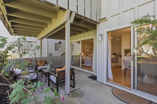 a view of a porch with chairs and potted plant
