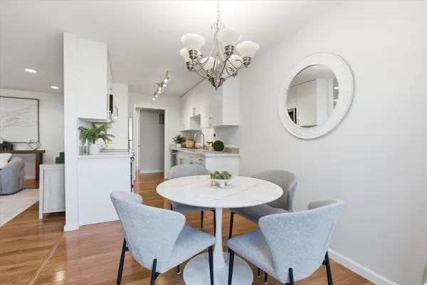 a view of a dining room with furniture and chandelier