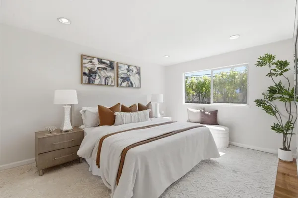 a bedroom with bed and a potted plant