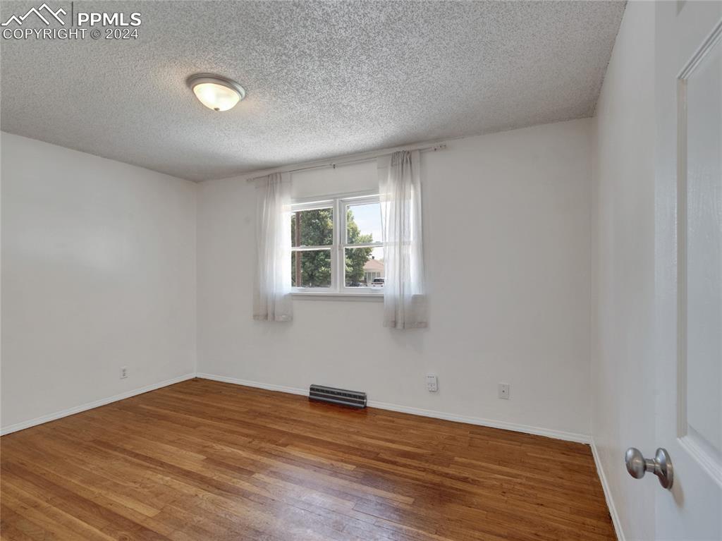 39 Duke Street Pueblo, CO 81005 - Photo 11 of 27 a view of empty room with wooden floor and fan