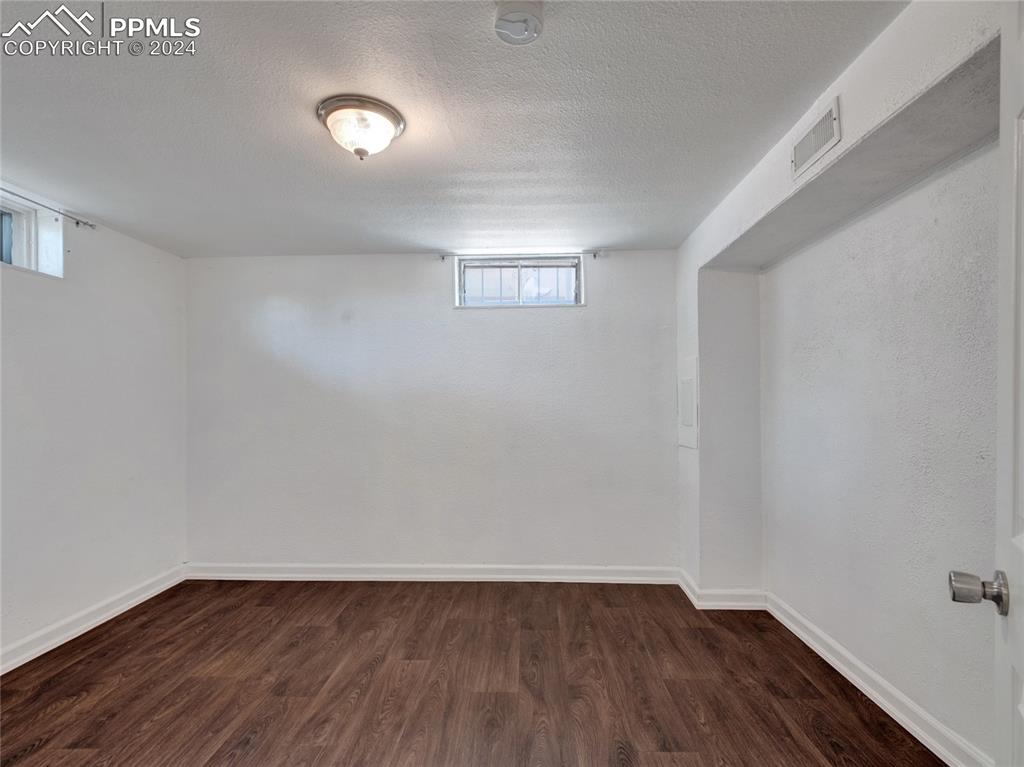 39 Duke Street Pueblo, CO 81005 - Photo 16 of 27 a view of an empty room with wooden floor and a window