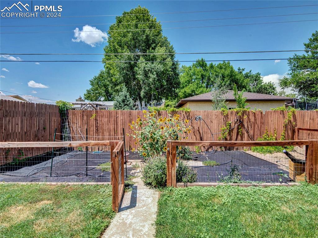 39 Duke Street Pueblo, CO 81005 - Photo 25 of 27 a view of backyard with table and chairs a barbeque with wooden fence