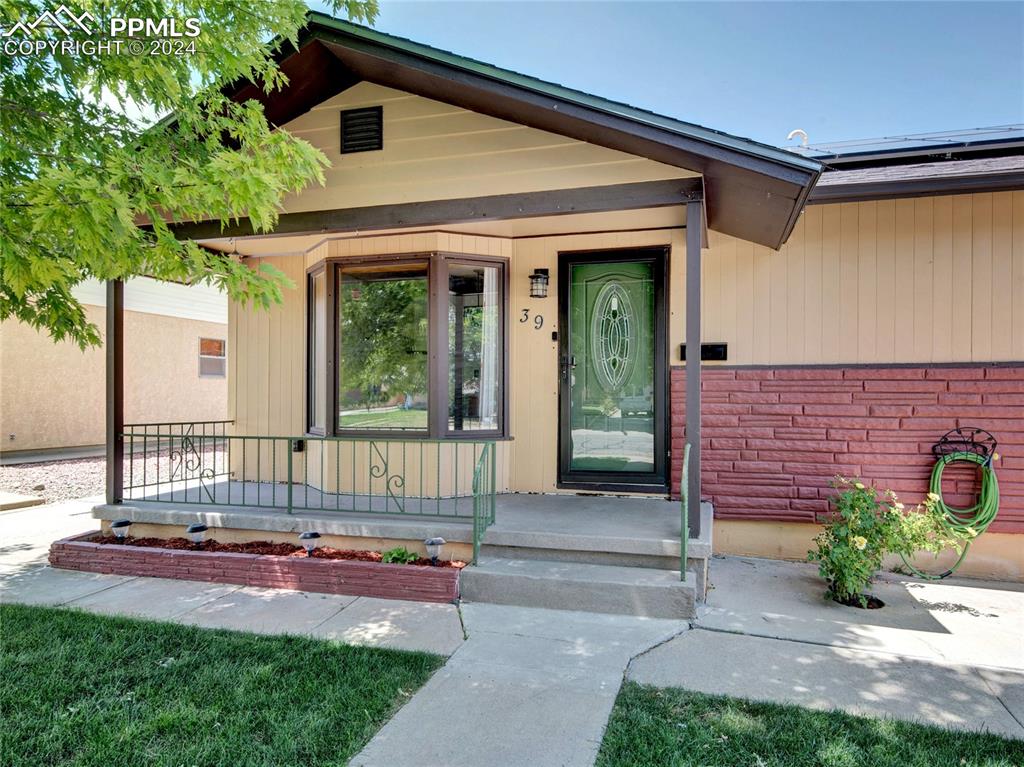 39 Duke Street Pueblo, CO 81005 - Photo 3 of 27 a front view of a house with a garden and patio