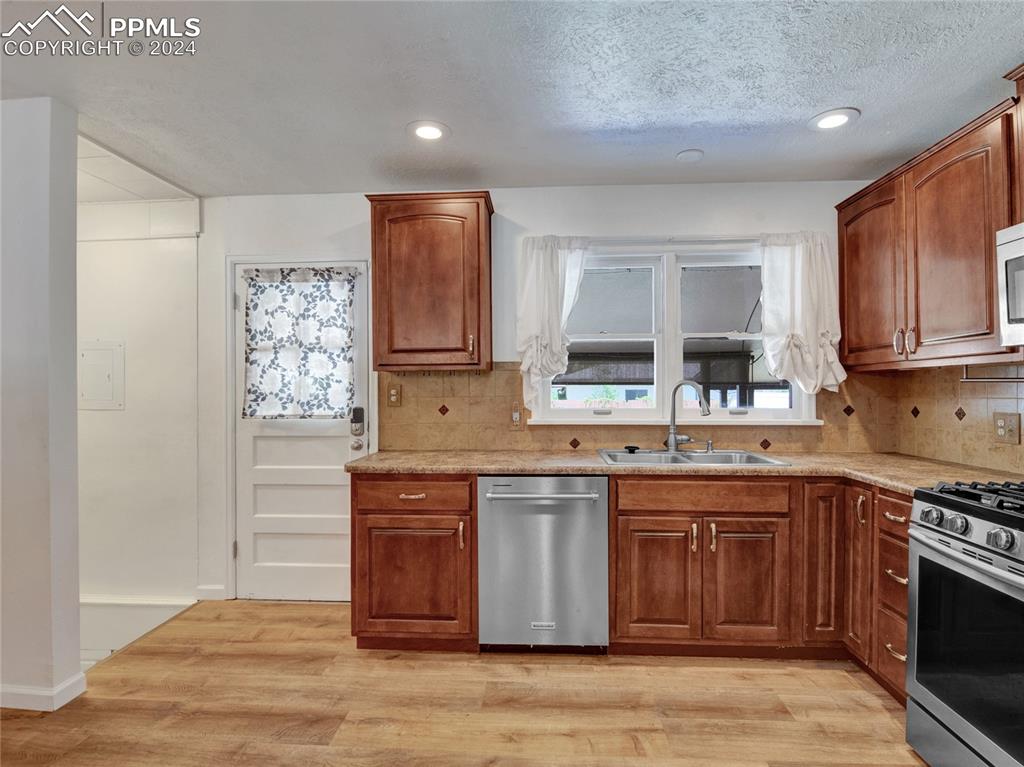 39 Duke Street Pueblo, CO 81005 - Photo 5 of 27 a kitchen with stainless steel appliances granite countertop a stove a sink and a microwave