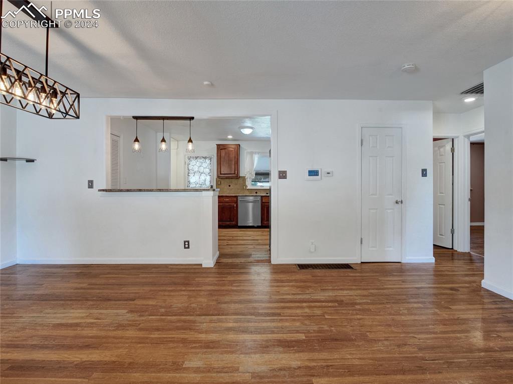 39 Duke Street Pueblo, CO 81005 - Photo 7 of 27 an empty room with wooden floor and windows
