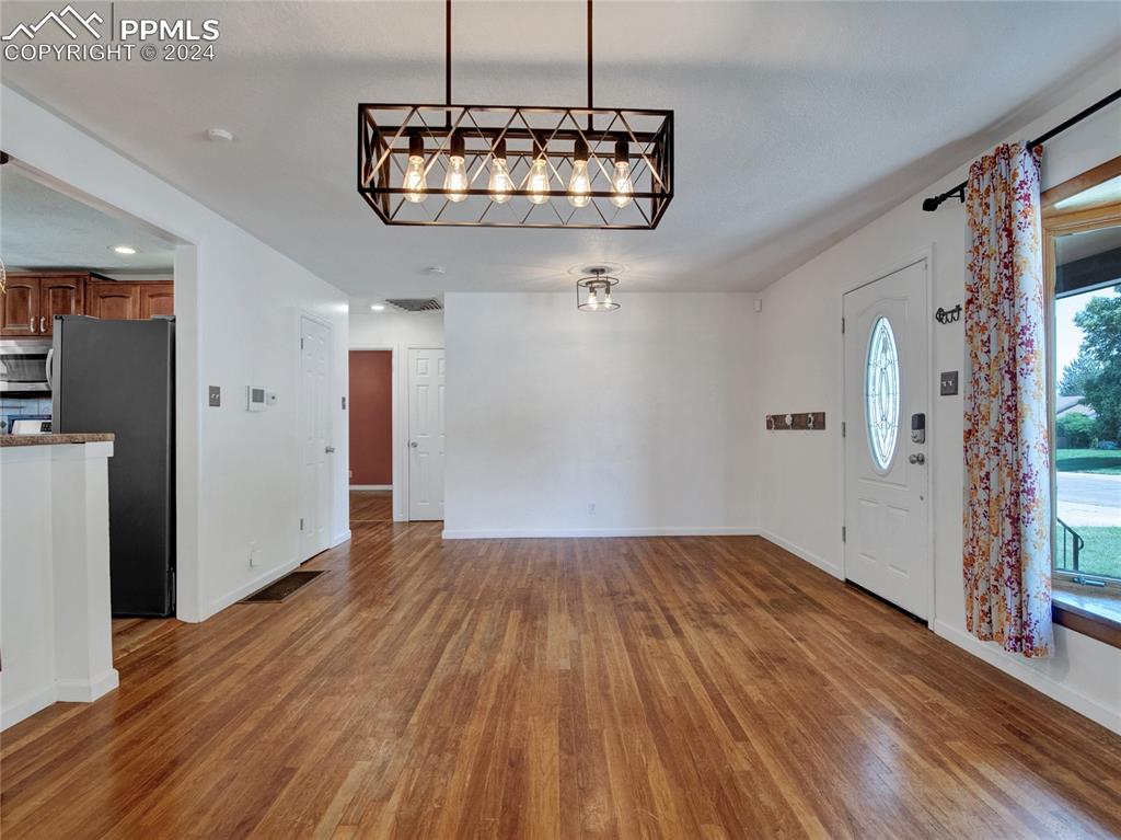 39 Duke Street Pueblo, CO 81005 - Photo 8 of 27 a view of a room with wooden floor staircase and a kitchen space