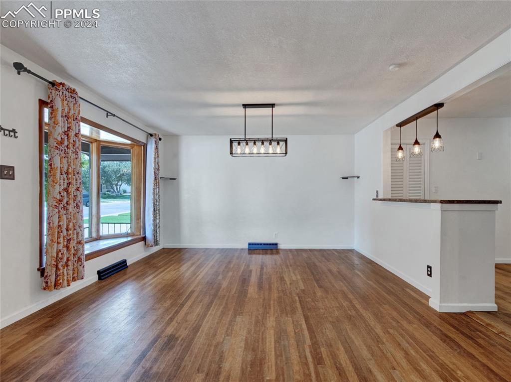 39 Duke Street Pueblo, CO 81005 - Photo 9 of 27 a view of an empty room with wooden floor and a window