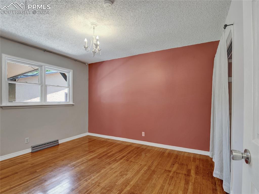 39 Duke Street Pueblo, CO 81005 - Photo 10 of 27 a view of an empty room with wooden floor and a window
