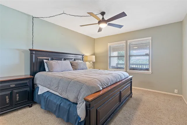a spacious bedroom with a bed and a chandelier