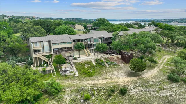 an aerial view of a house with a yard