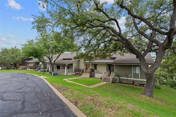 a front view of a house with a yard table and chairs