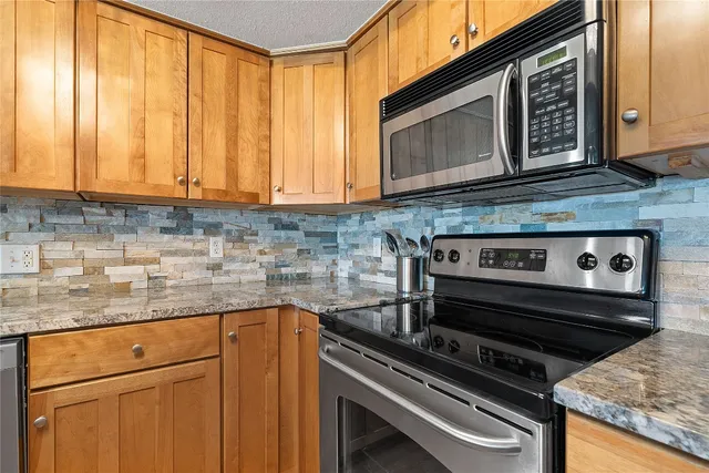 a kitchen with wooden cabinets and a stove top oven