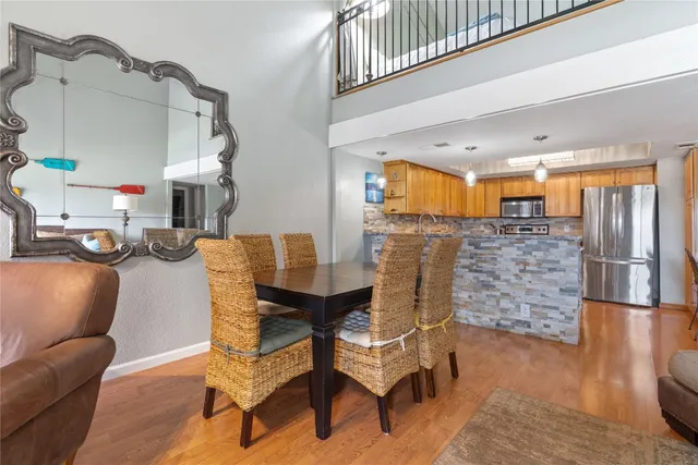 a dining room with furniture and wooden floor