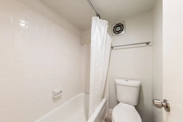 a bathroom with a toilet a sink and a bathtub