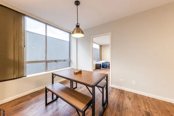 a view of a dining room with furniture window and wooden floor