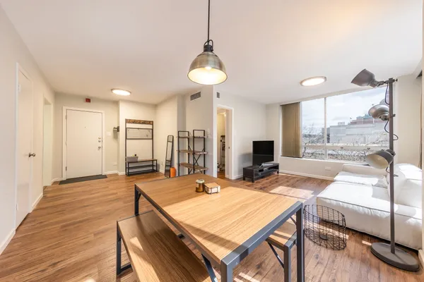 a large kitchen with a table and chairs