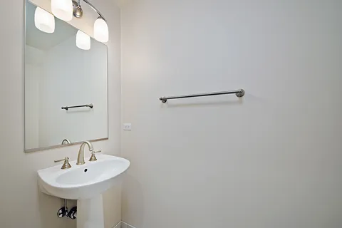 a bathroom with a sink a mirror and vanity