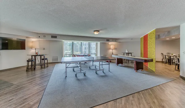 a view of a living room and kitchen with granite countertop