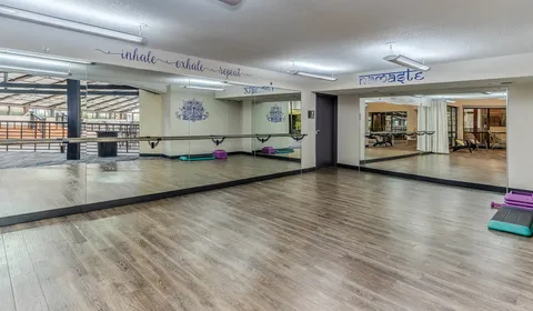 a kitchen with granite countertop shower a sink and dishwasher a refrigerator