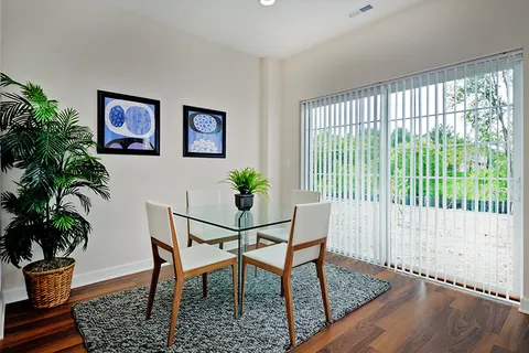 a dining room with furniture and wooden floor