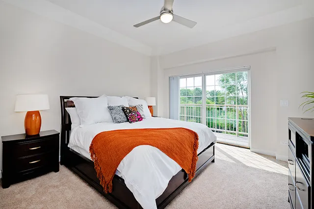 a bed sitting in a bedroom next to a window