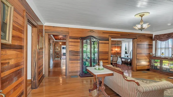 a view of a livingroom with furniture wooden floor and windows