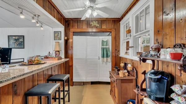 a dining room with furniture and wooden floor